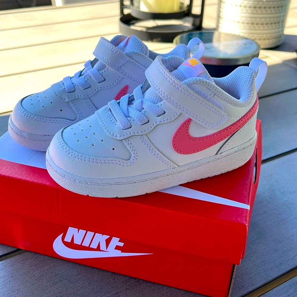 Brand new Nike sneakers white with pink swoosh.  Never worn size 8 toddler
